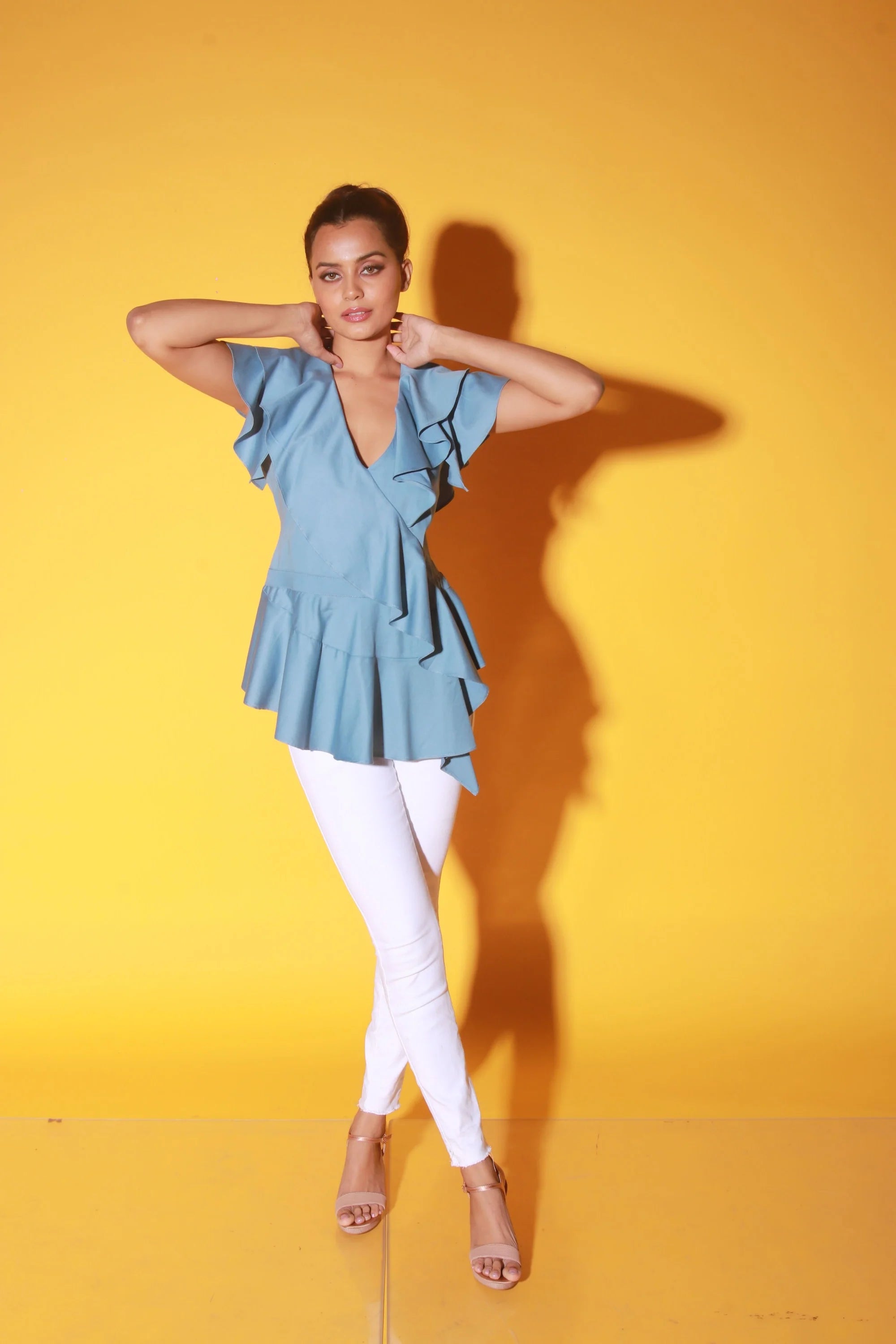 Slate blue peplum top with ruffles and black zipper at the back