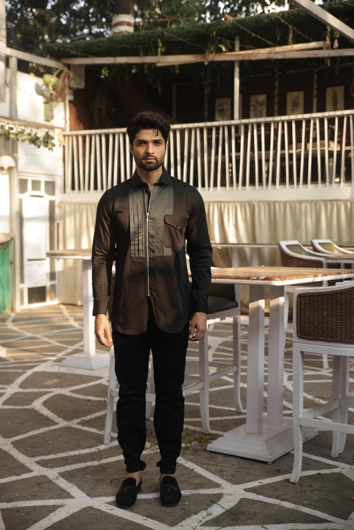 Black shirt with green pleates on the chest and zippered placket