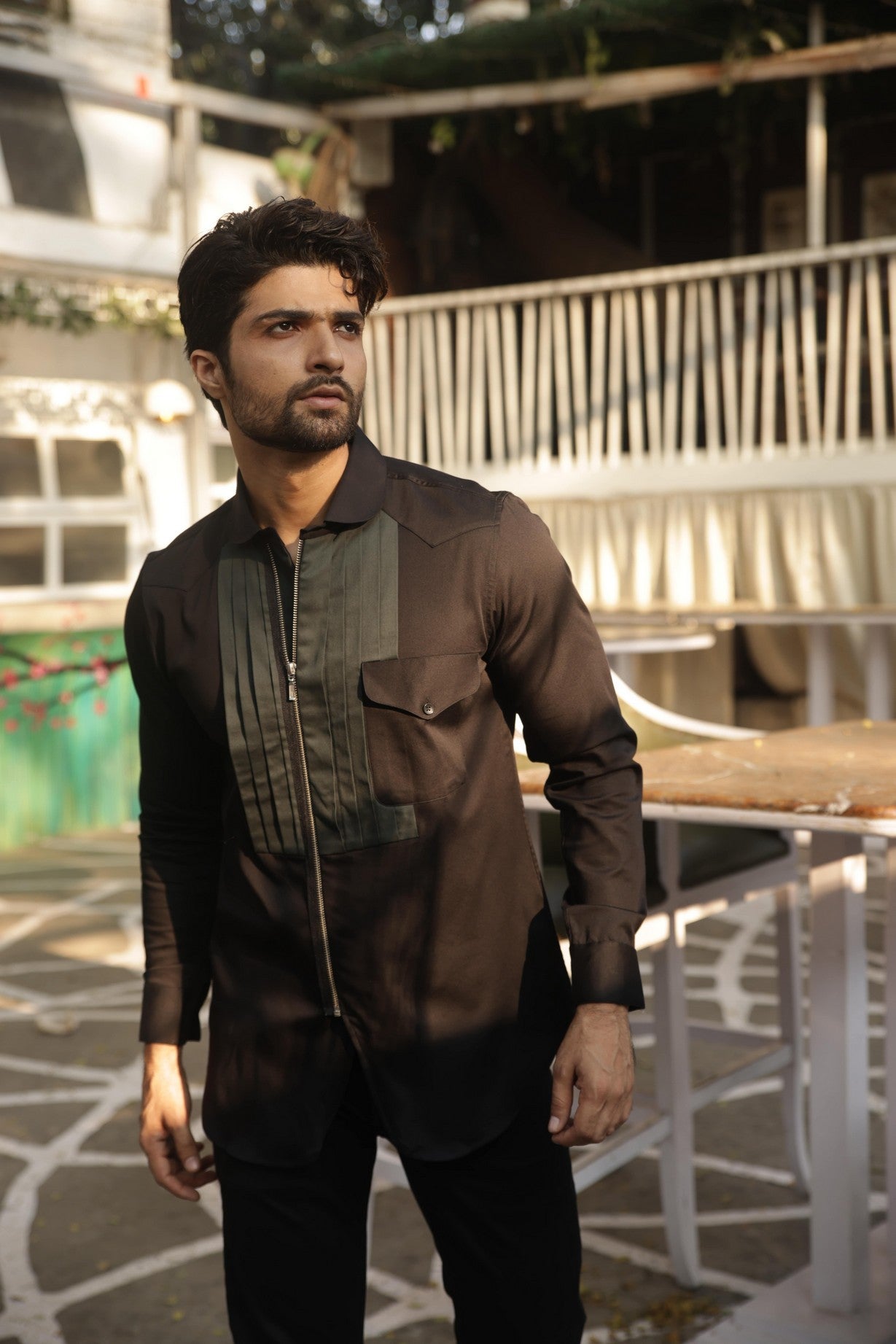 Black shirt with green pleates on the chest and zippered placket