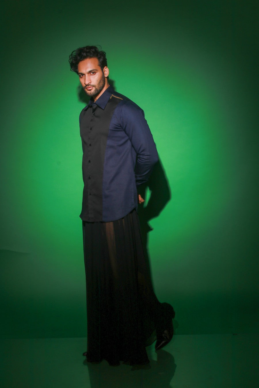 Blue shirt with black diagonal flap and black zipper feature on one shoulder
