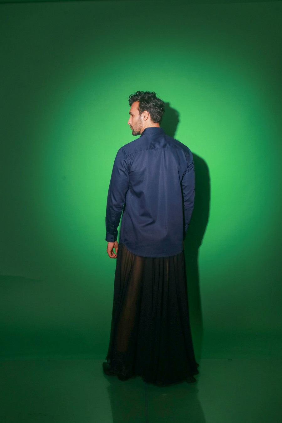 Blue shirt with black diagonal flap and black zipper feature on one shoulder