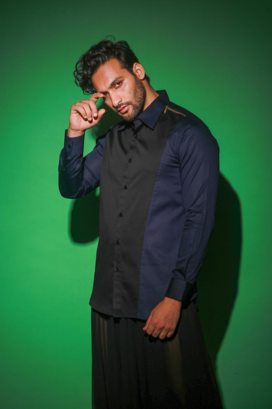 Blue shirt with black diagonal flap and black zipper feature on one shoulder