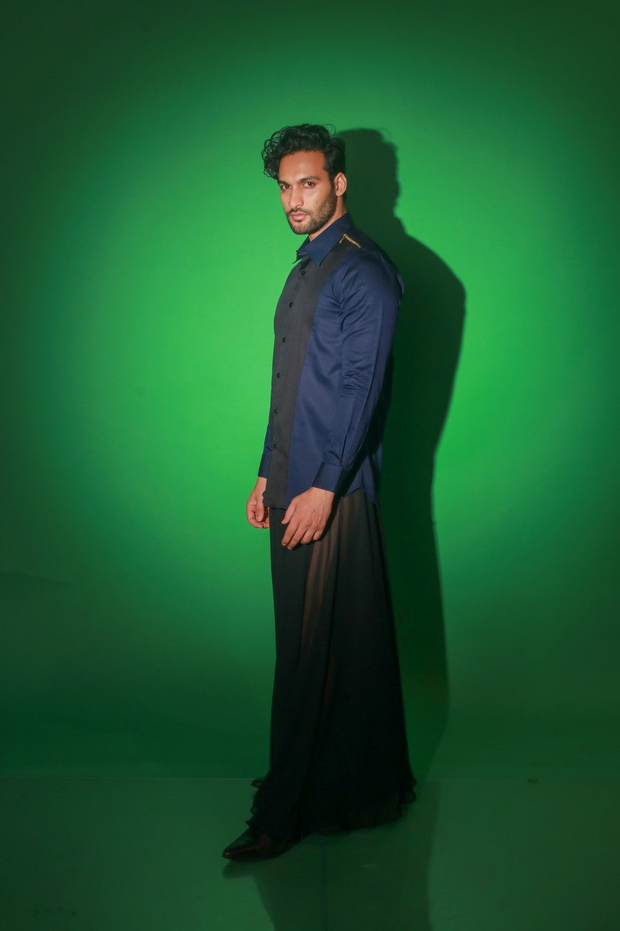 Blue shirt with black diagonal flap and black zipper feature on one shoulder