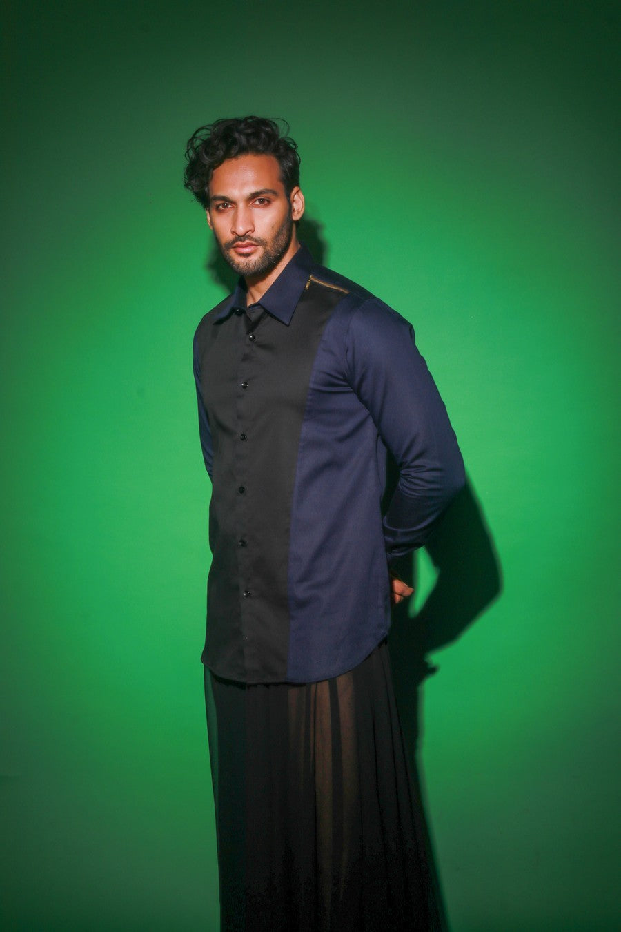 Blue shirt with black diagonal flap and black zipper feature on one shoulder