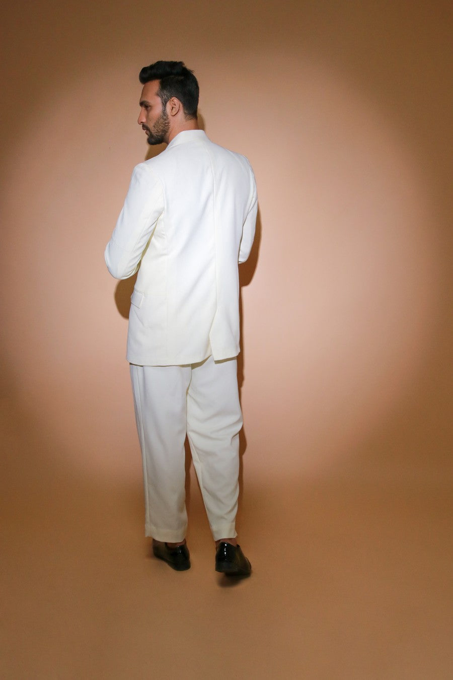 Cream jacket with self stitching panels and straight pleated pants