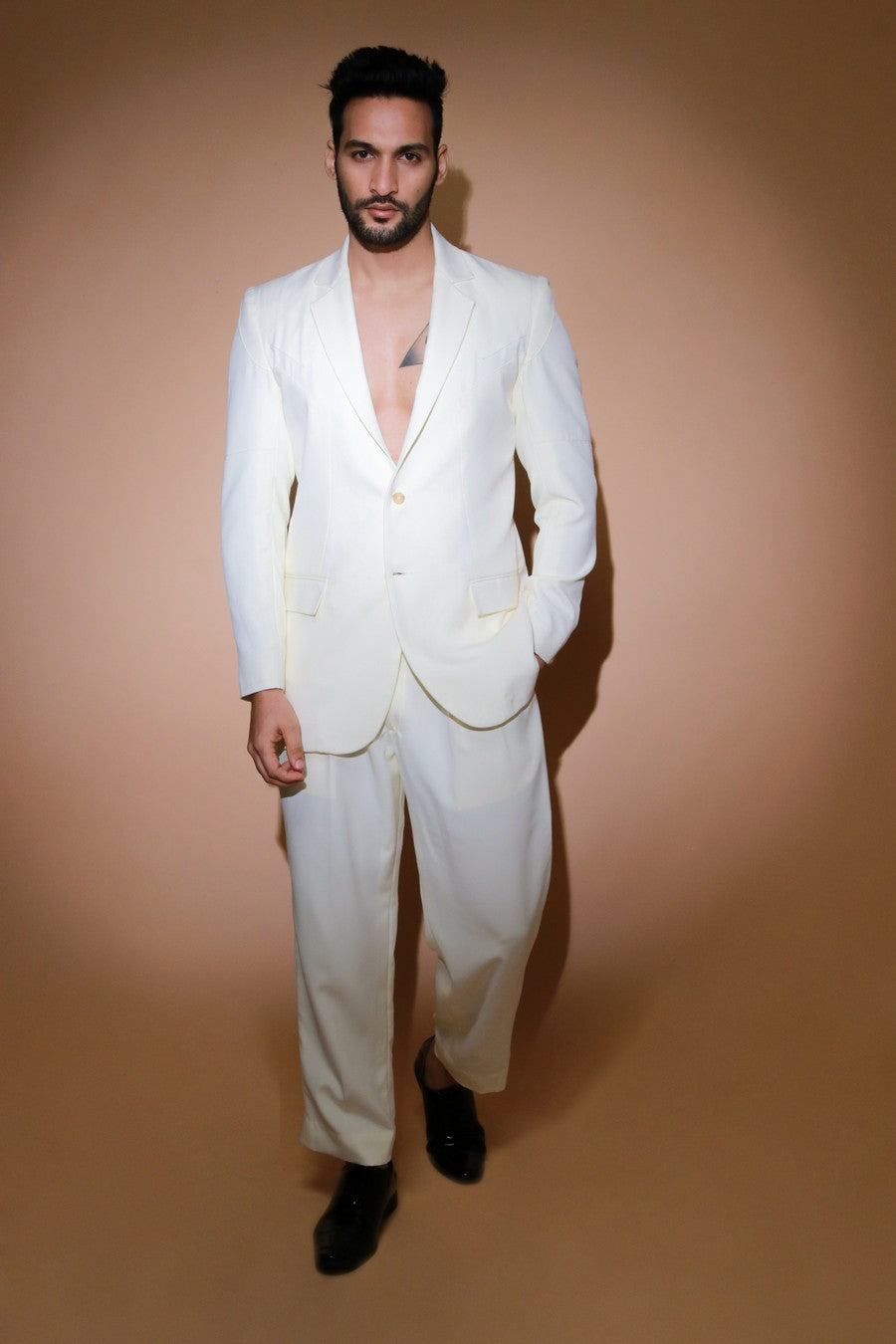 Cream jacket with self stitching panels and straight pleated pants