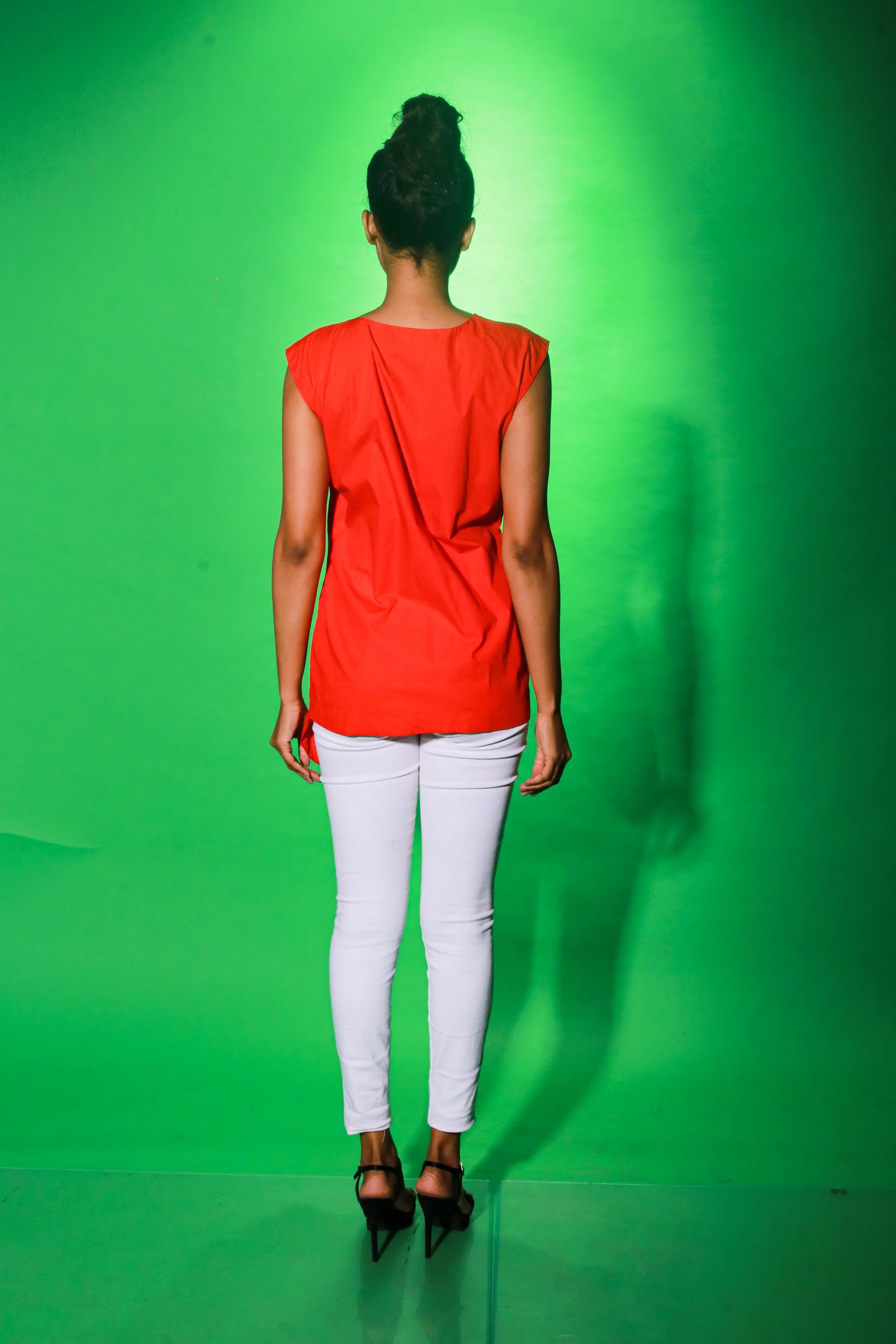 Coral sleeveless top with off center zipper placket and frill