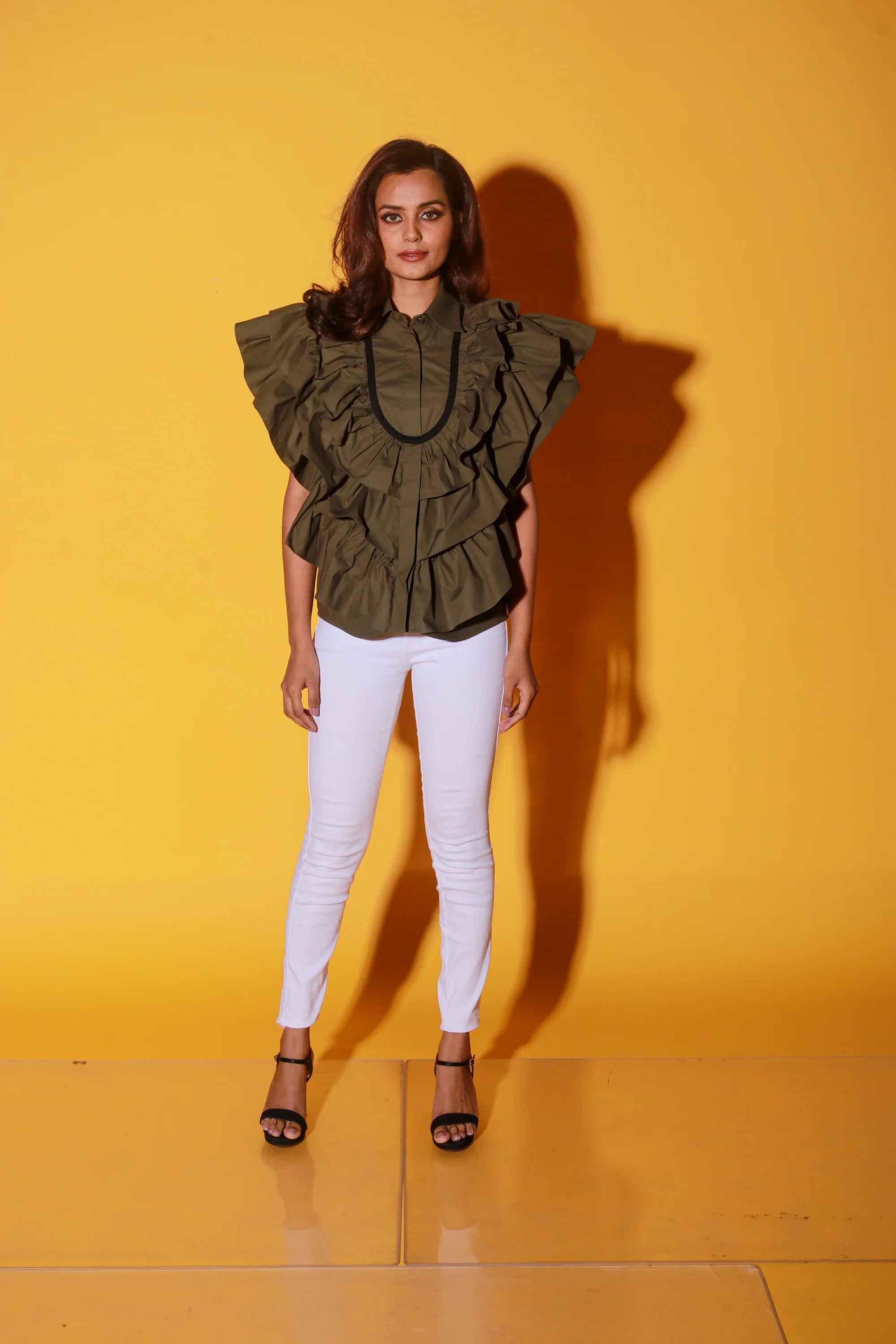 Olive green shirt with ruffles and black pattis on the yoke