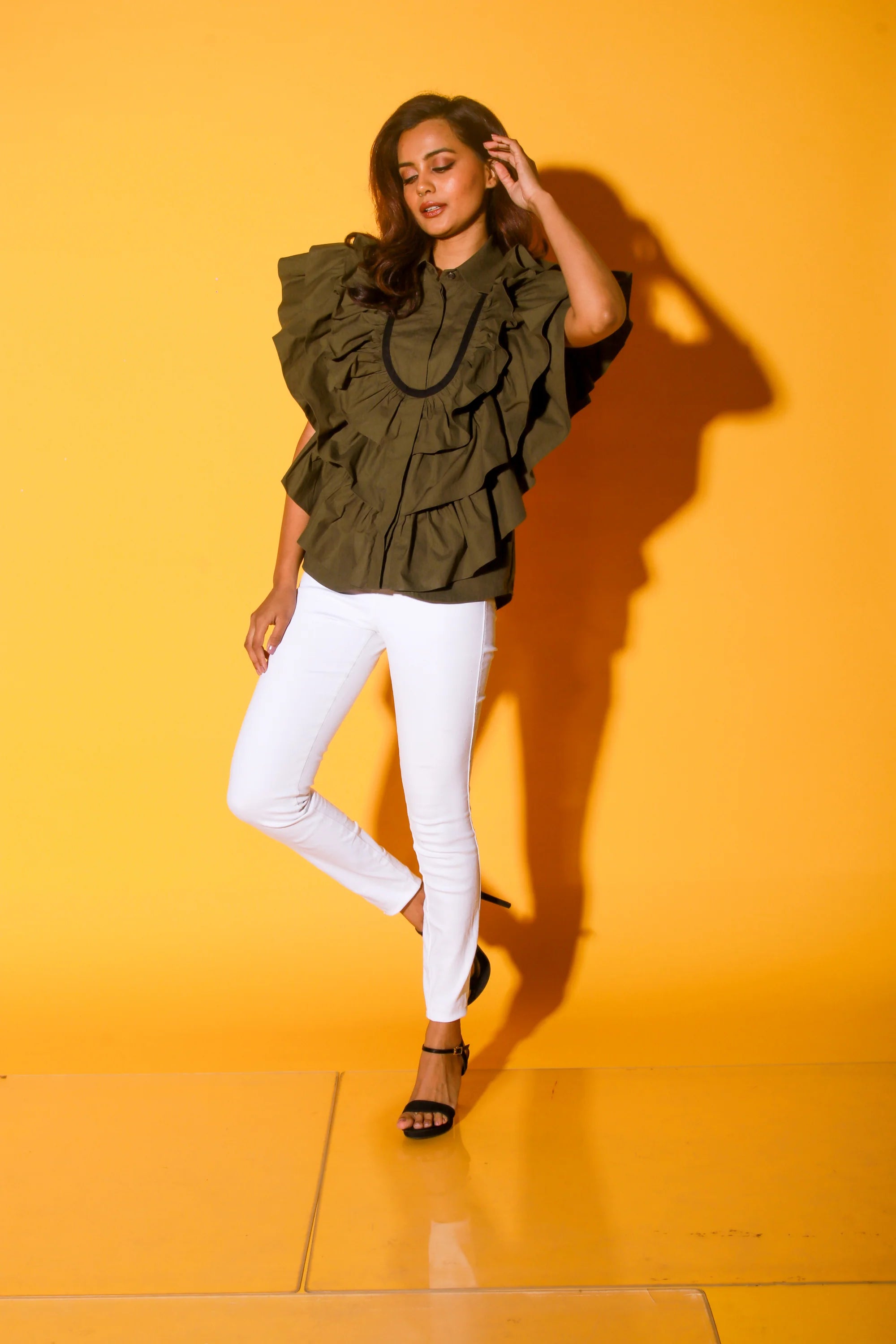 Olive green shirt with ruffles and black pattis on the yoke