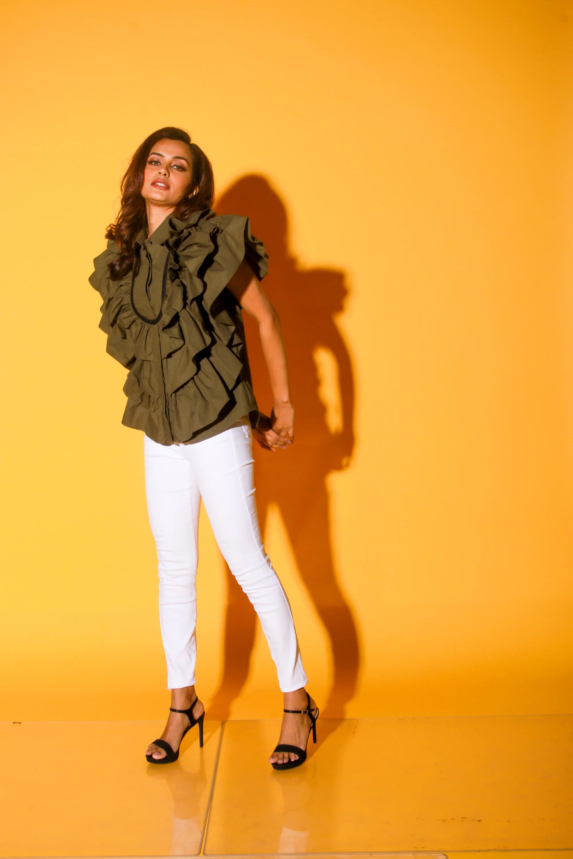 Olive green shirt with ruffles and black pattis on the yoke