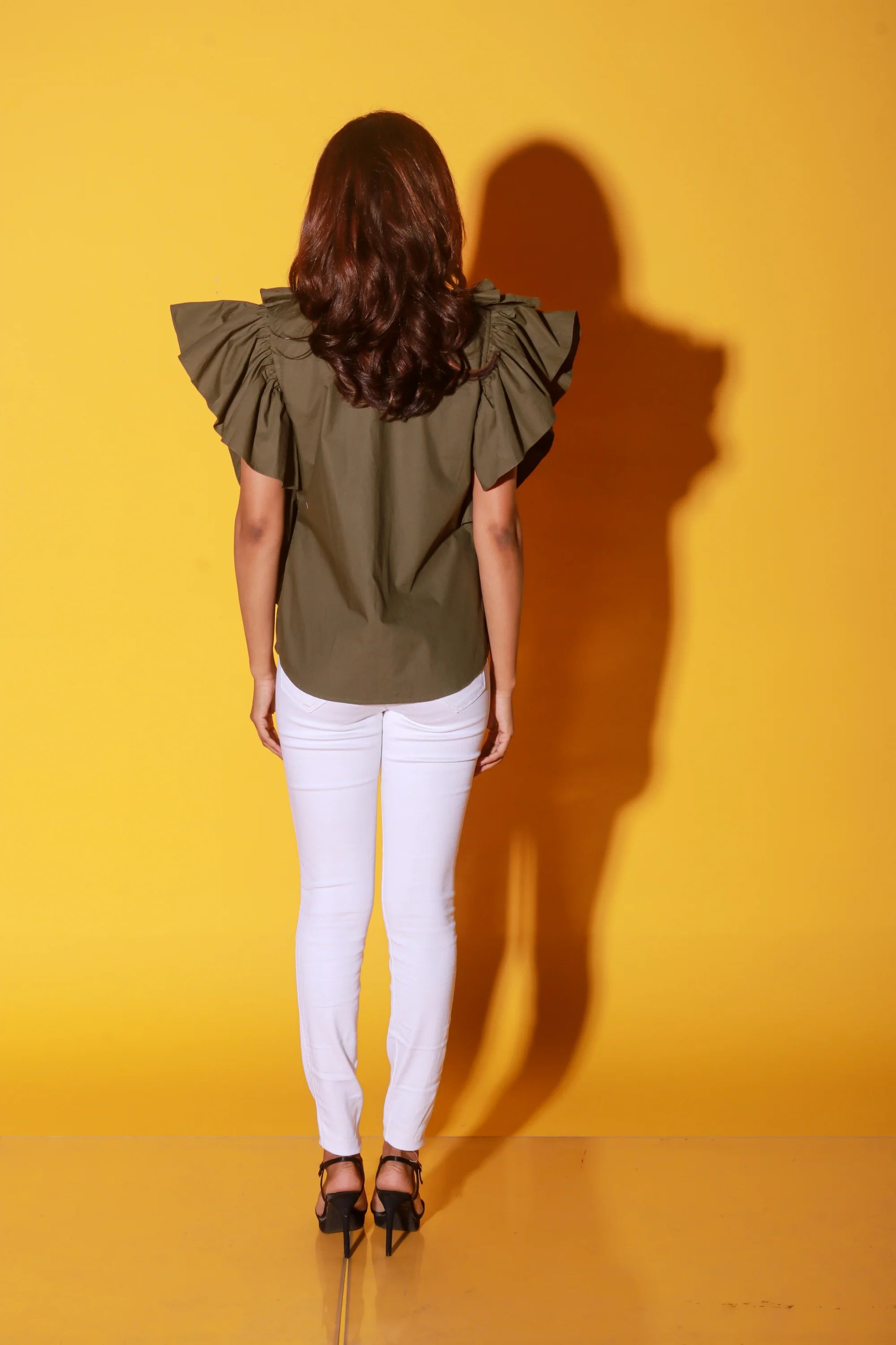 Olive green shirt with ruffles and black pattis on the yoke