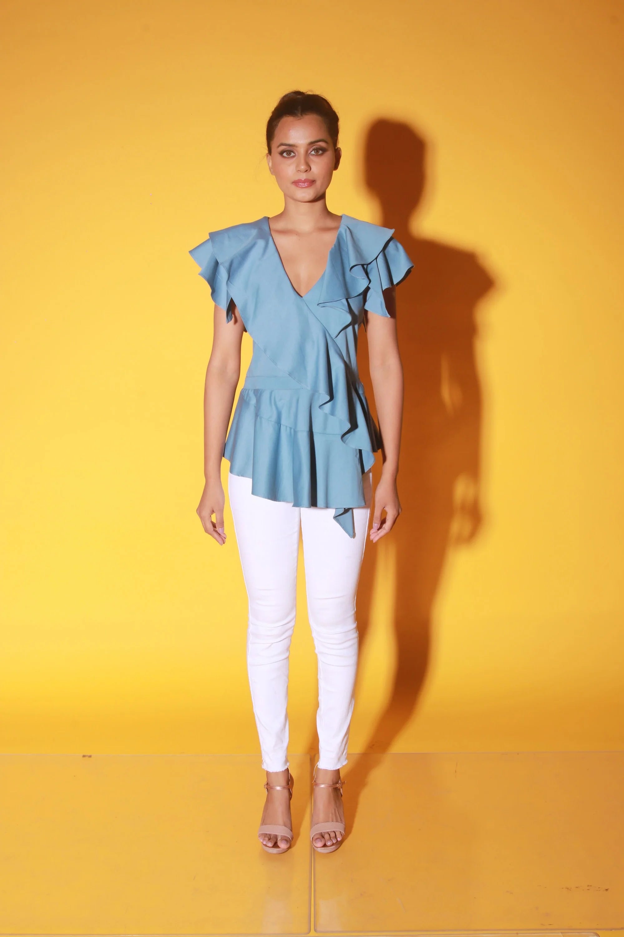Slate blue peplum top with ruffles and black zipper at the back