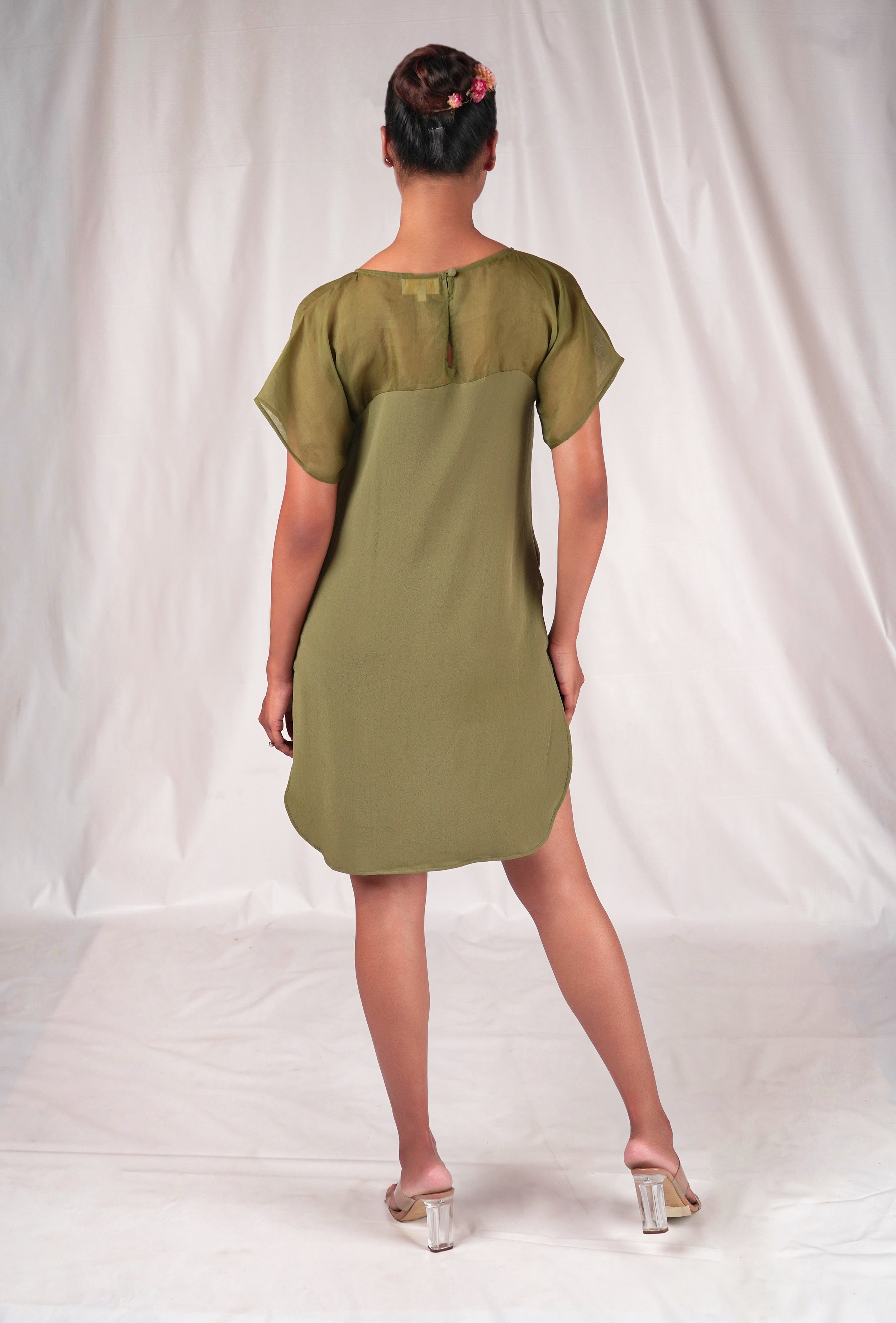 Green dress featuring floral embroidery motifs