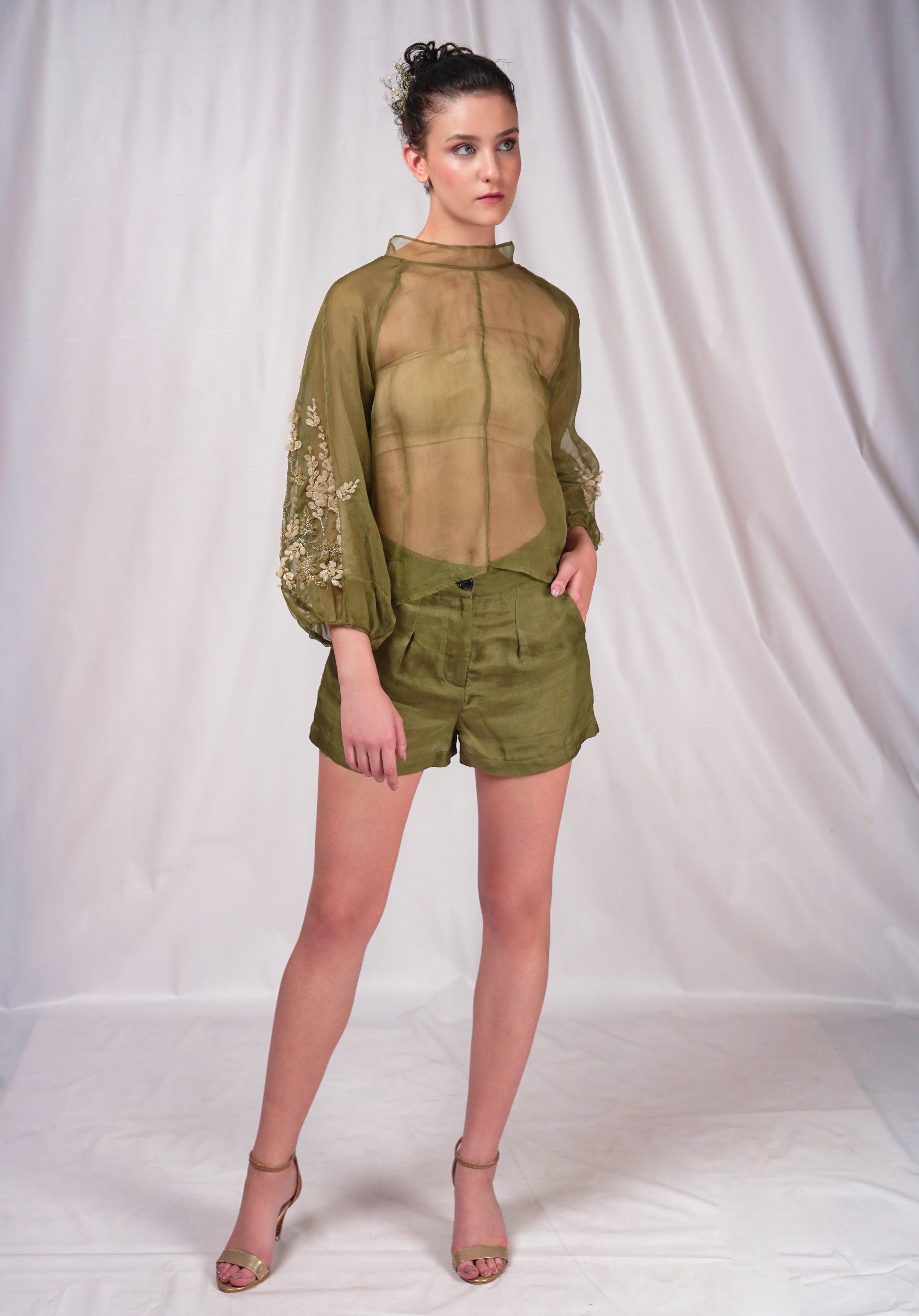 Green mid-thigh length shorts.