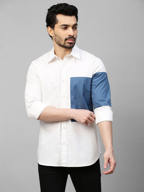 White shirt with slate blue patch on left sleeve and chest with button detailing