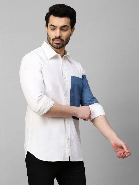 White shirt with slate blue patch on left sleeve and chest with button detailing