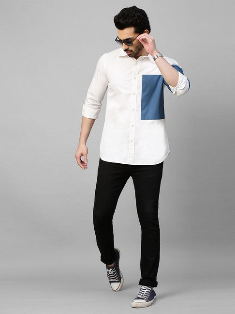 White shirt with slate blue patch on left sleeve and chest with button detailing