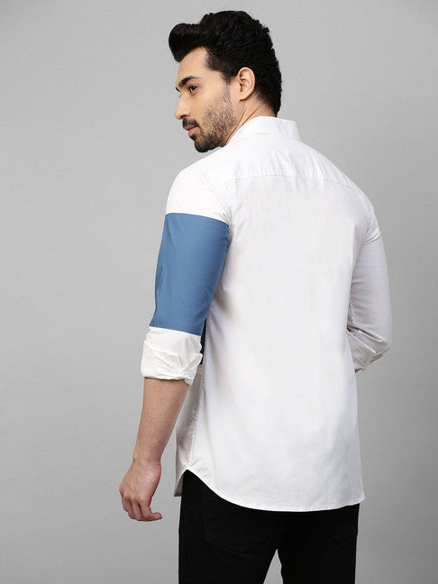 White shirt with slate blue patch on left sleeve and chest with button detailing