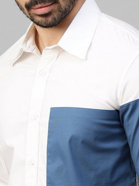 White shirt with slate blue patch on left sleeve and chest with button detailing