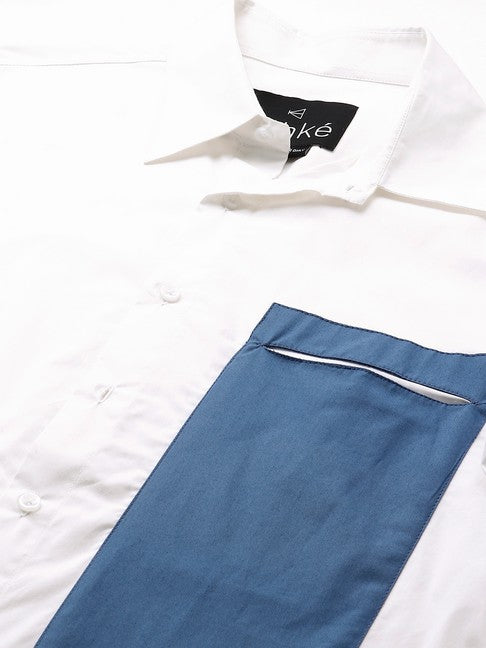 White shirt with slate blue patch on one side with slit pocket feature