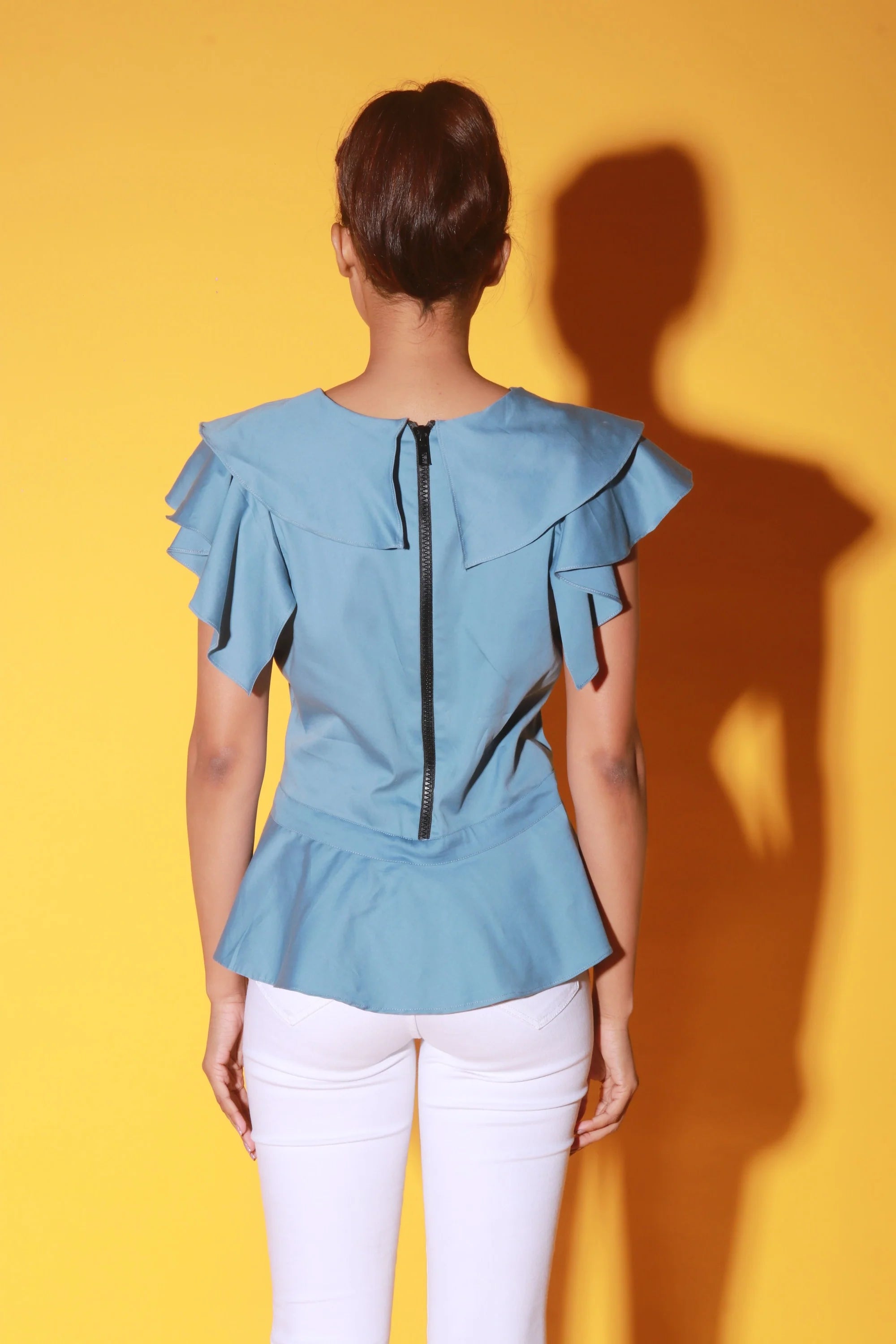 Slate blue peplum top with ruffles and black zipper at the back