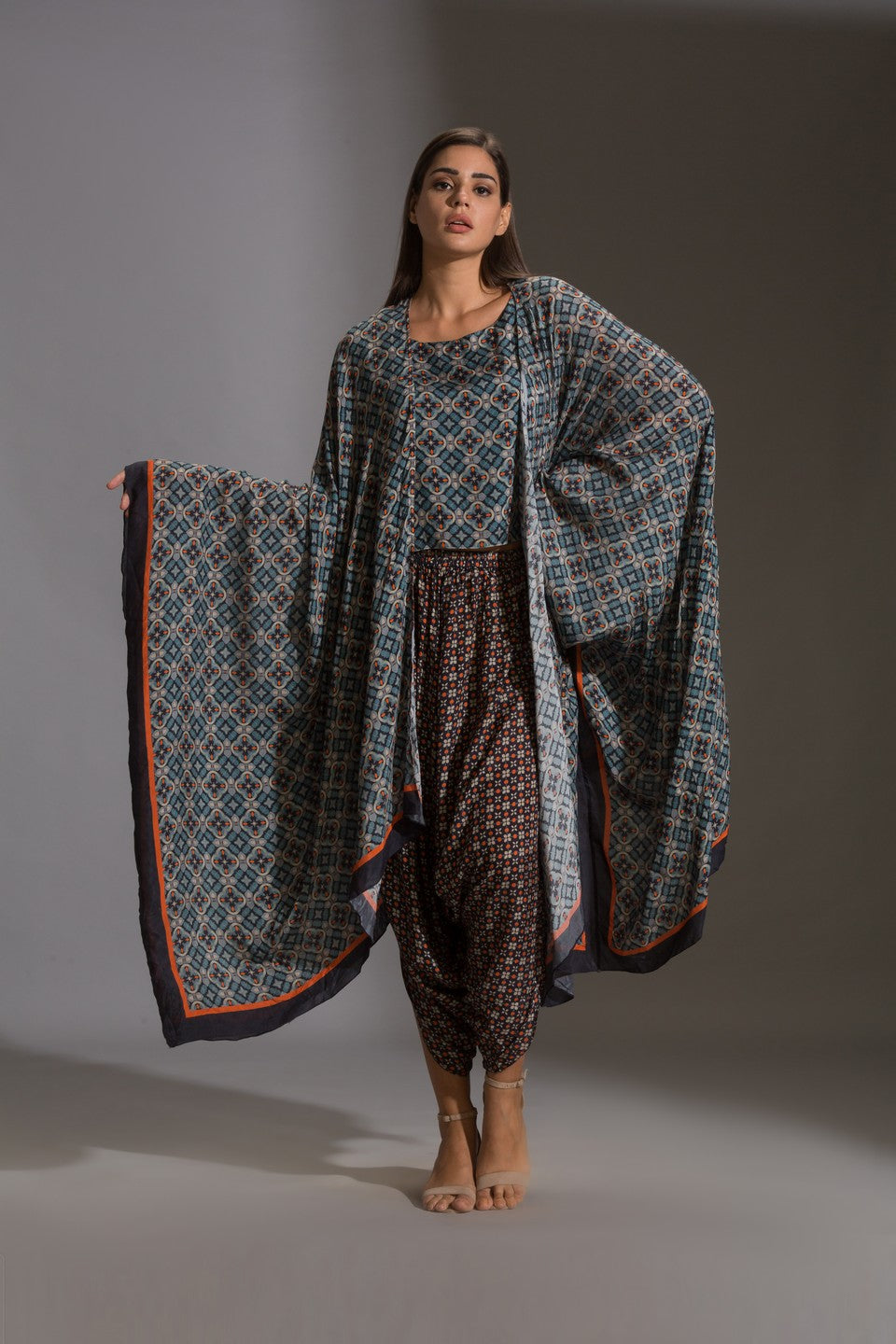 Top paired with dhoti pants and cape