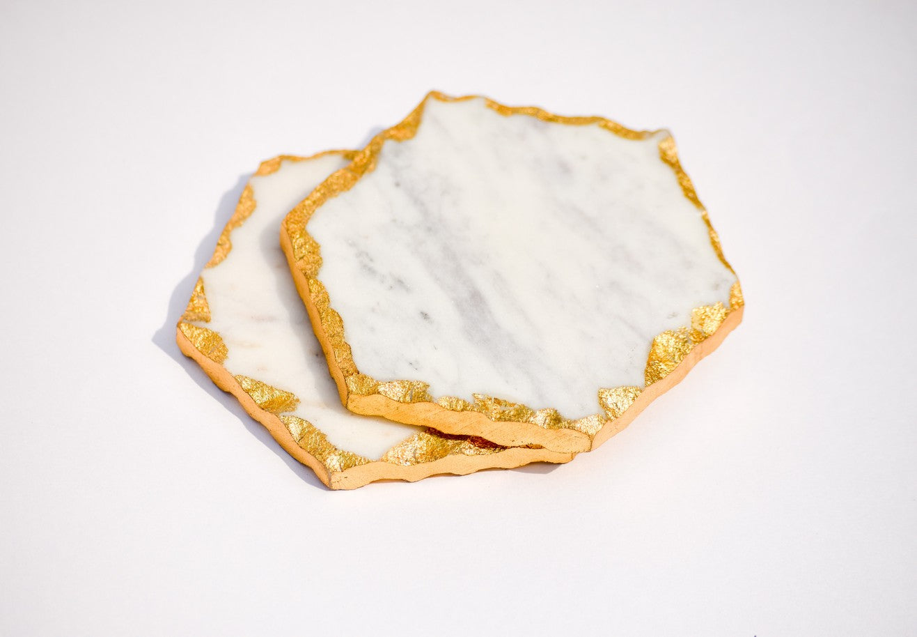 Hexagon white and gold toned marble coasters