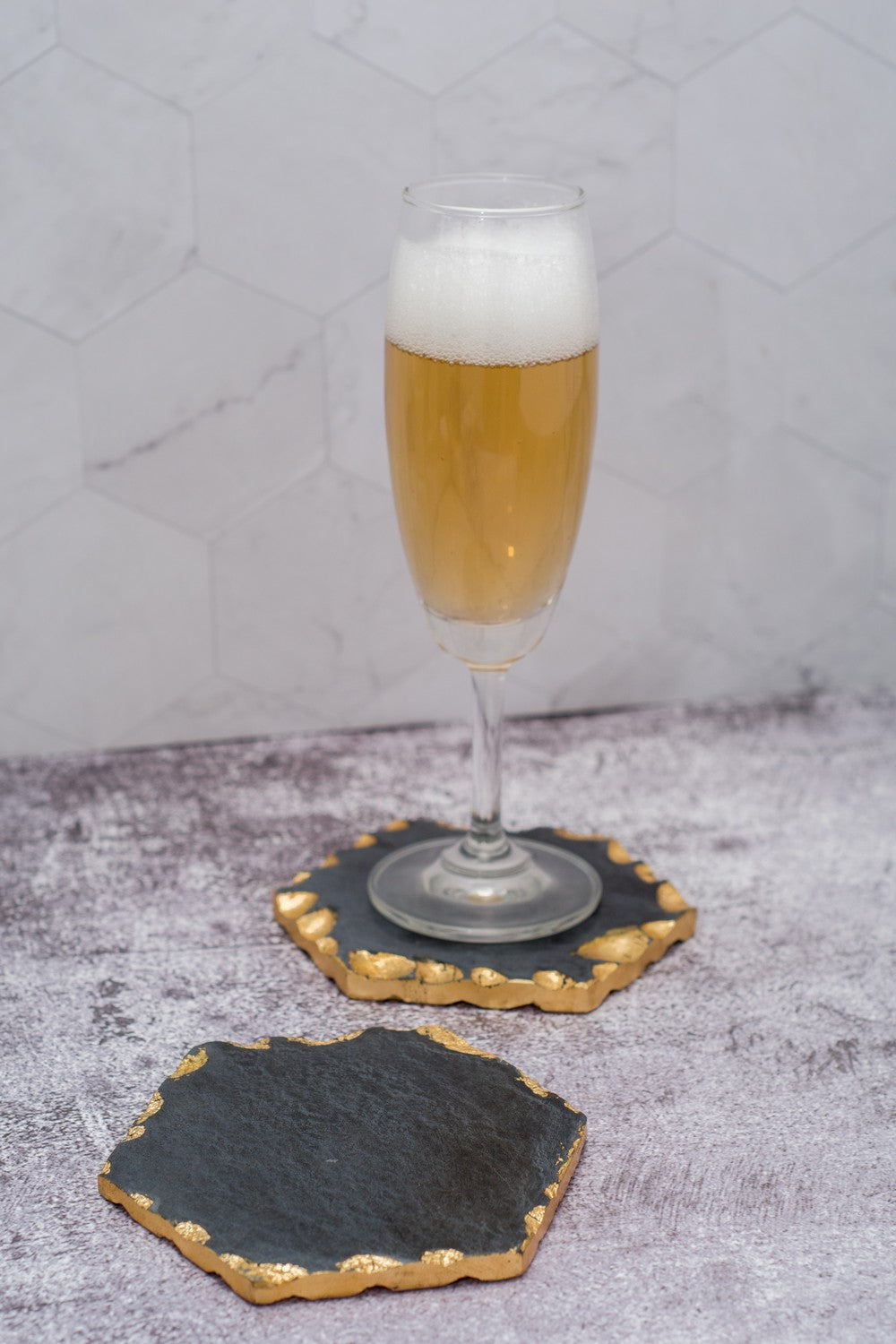 Hexagon black and gold toned marble coasters