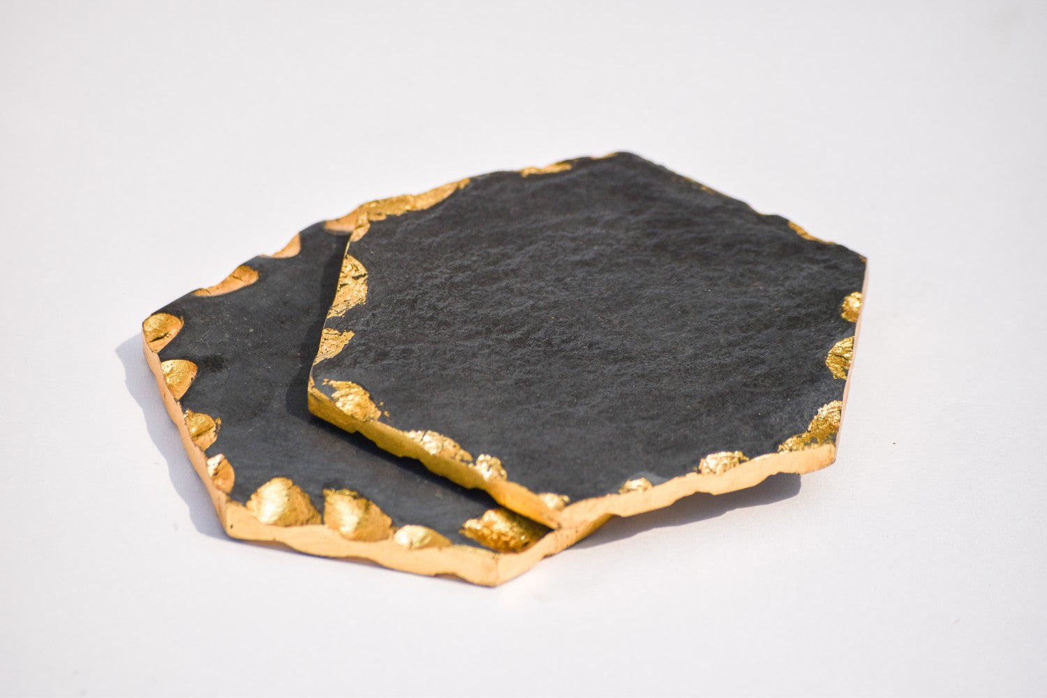 Hexagon black and gold toned marble coasters