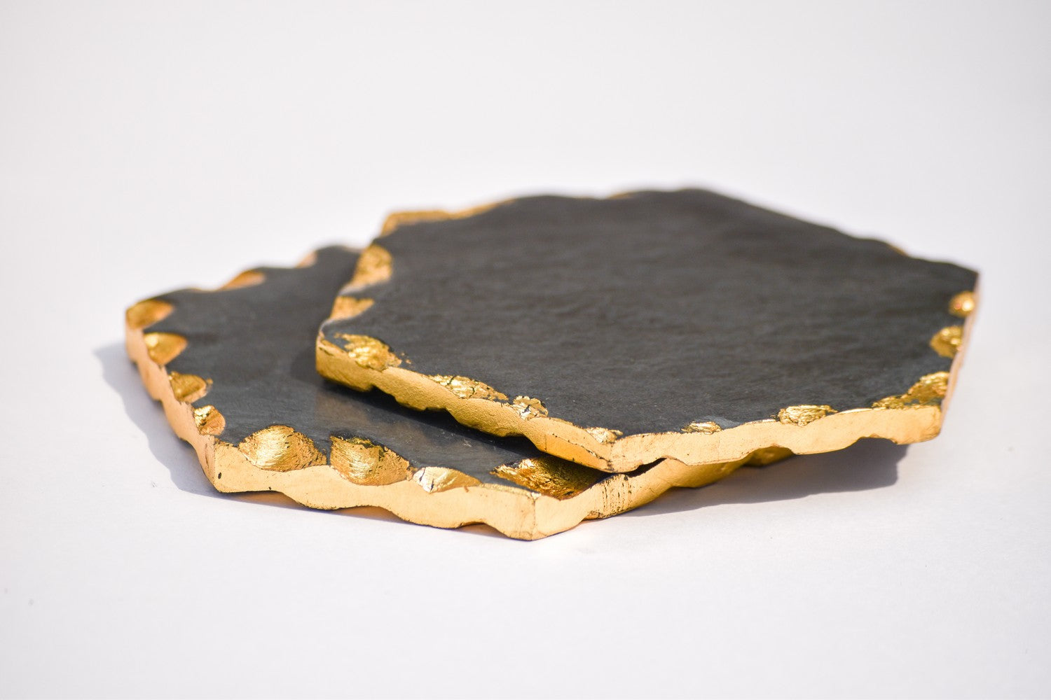 Hexagon black and gold toned marble coasters