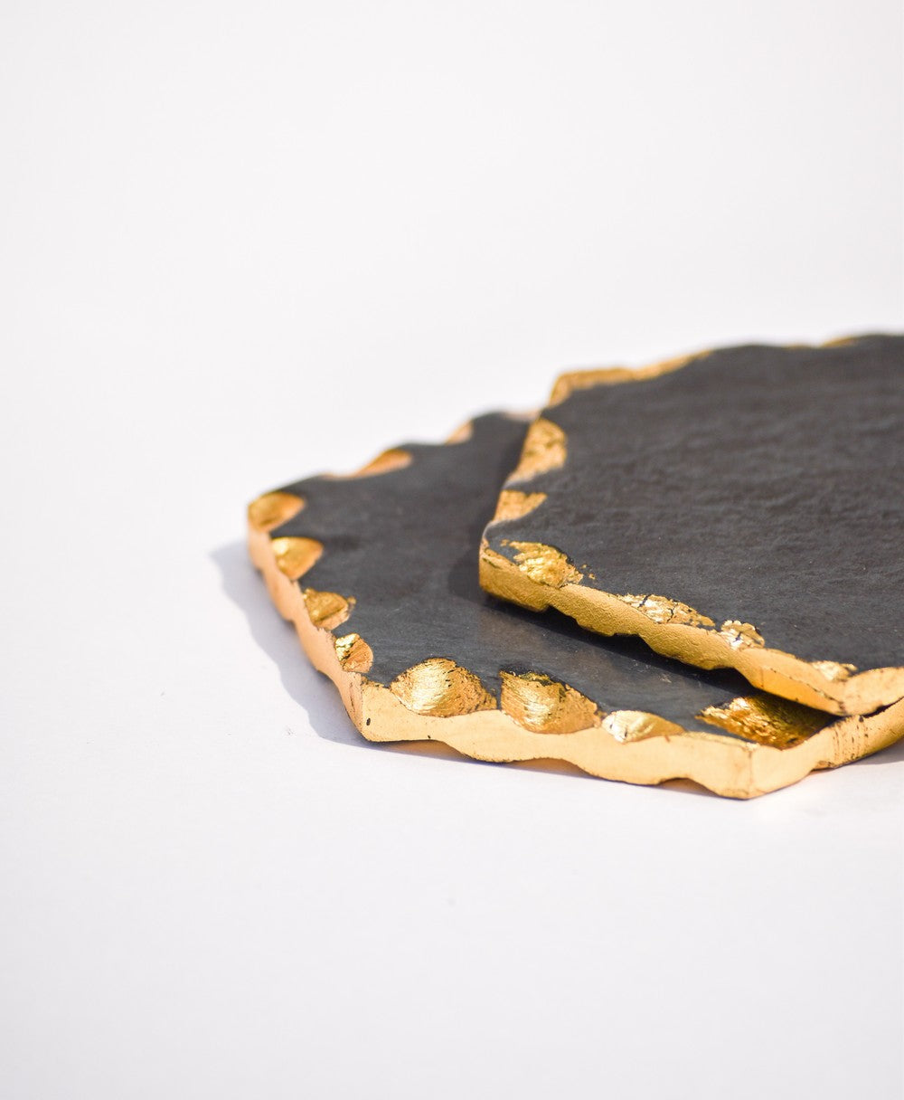 Hexagon black and gold toned marble coasters